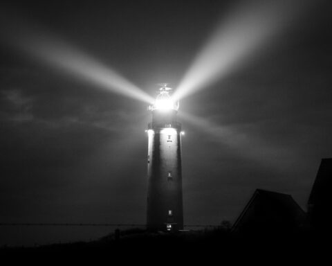 Light from a lighthouse shining in the dark