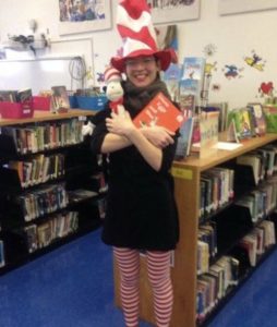 A lunatic librarian dressed as the Cat in the Hat